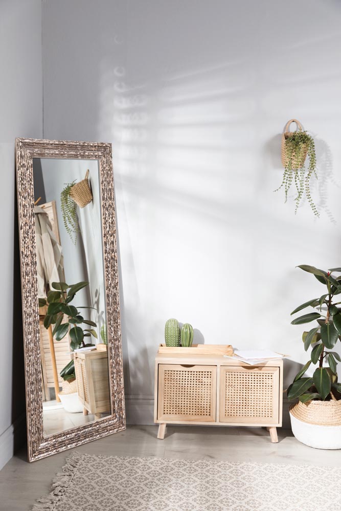 Stylish hallway room interior with wooden commode and large mirr