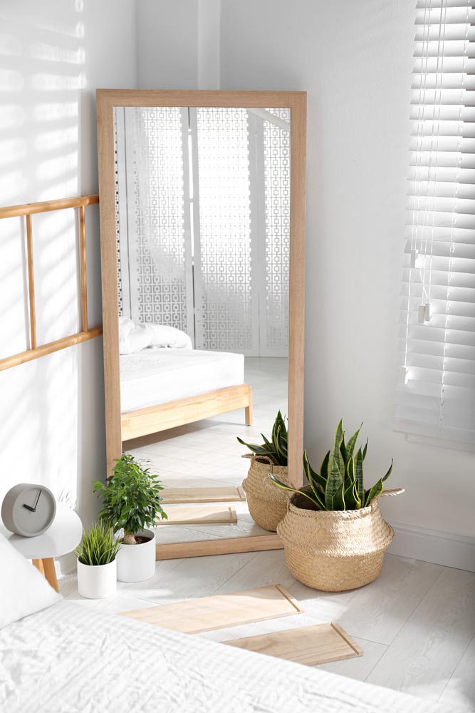 Modern bedroom interior with stylish large mirror