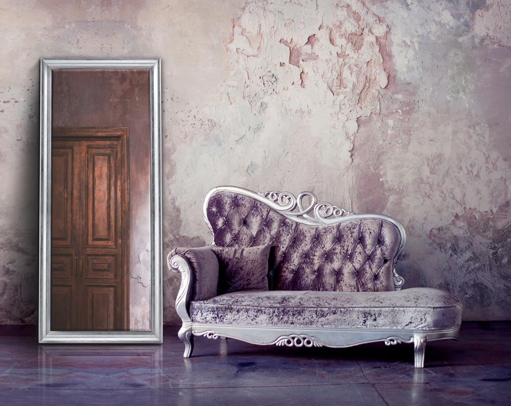 Grunge Styled Interior. Beautiful sofa in classical style on a background of textured walls. Purple toning