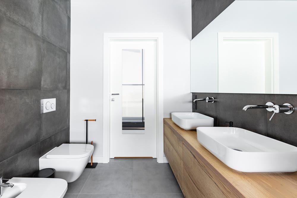 Double sinks in elegant white, concrete and wooden bathroom inte